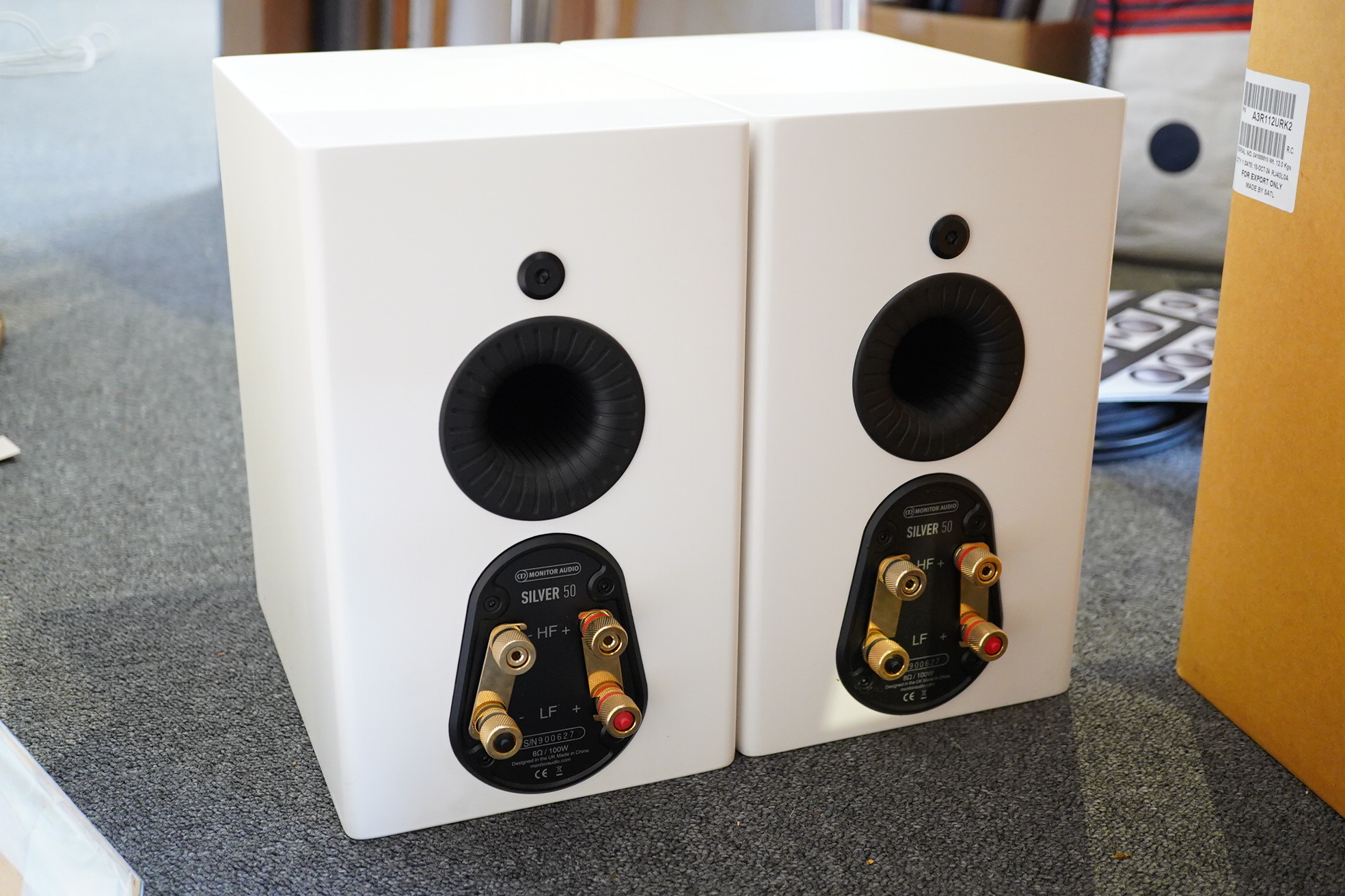 A pair of Monitor Audio Silver Series ‘Silver 50’ stereo monitor speakers in satin white cases, height 27cm, width 16.5cm, depth 25cm, together with the silver series specification booklet and two related audio cables
